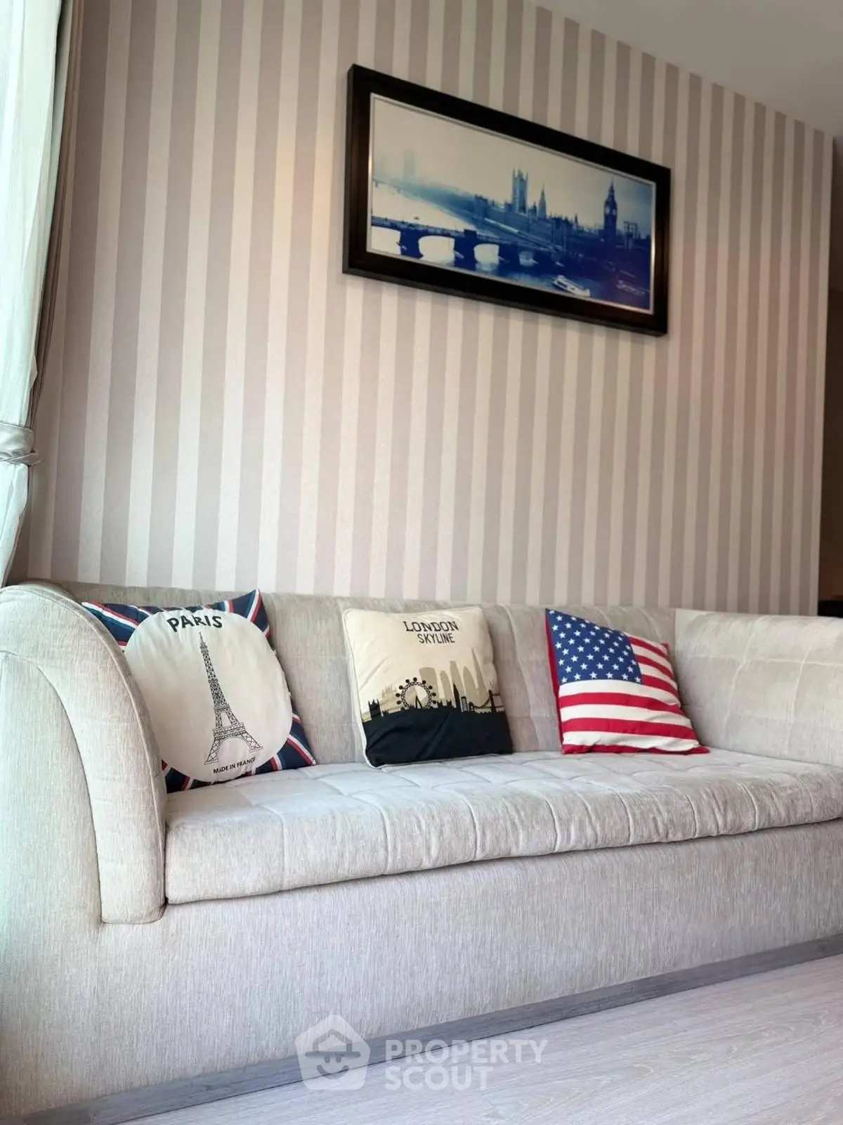 Stylish living room with elegant sofa and decorative pillows, perfect for modern urban living.