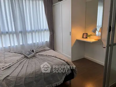 Cozy bedroom with natural light, modern decor, and built-in wardrobe for stylish living.