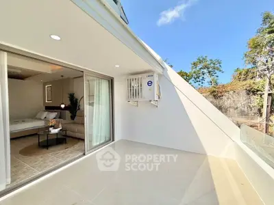 Spacious balcony with modern interior view and lush greenery