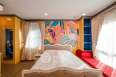 Vibrant bedroom with colorful mural and elegant furnishings