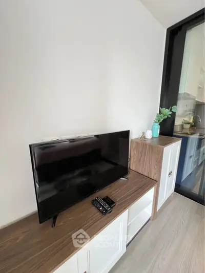 Modern living room with sleek TV setup and stylish wooden cabinetry