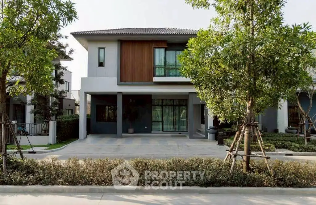 Modern two-story house with landscaped front yard and spacious driveway