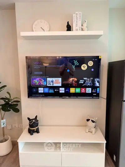 Modern living room with wall-mounted TV and stylish decor