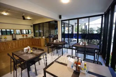 Spacious dining area with modern decor and large windows for natural light.