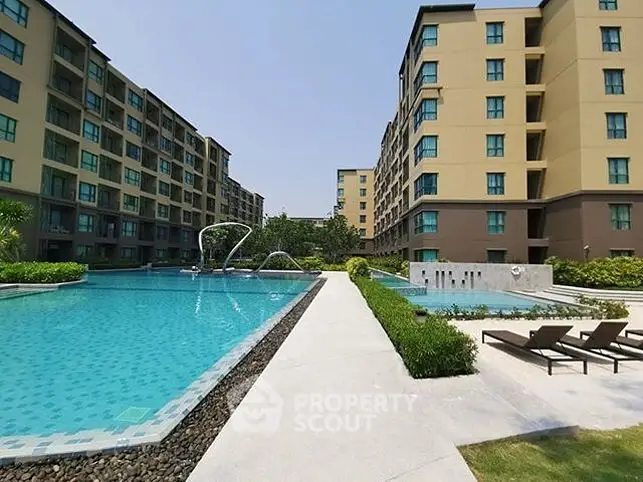 Luxurious apartment complex with stunning pool and modern amenities.