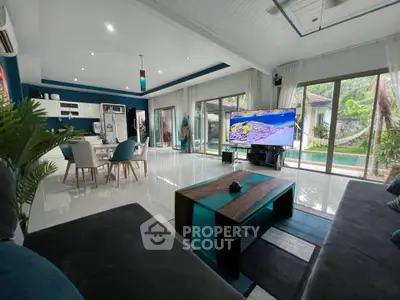 Spacious modern living room with pool view and open kitchen layout