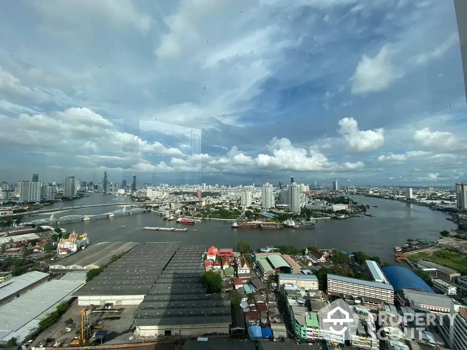 Stunning cityscape view with river and skyline from high-rise building window.