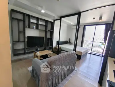 Modern studio apartment with open layout and balcony view