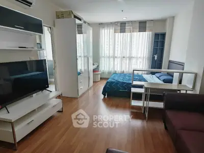 Modern studio apartment with large windows and stylish furnishings
