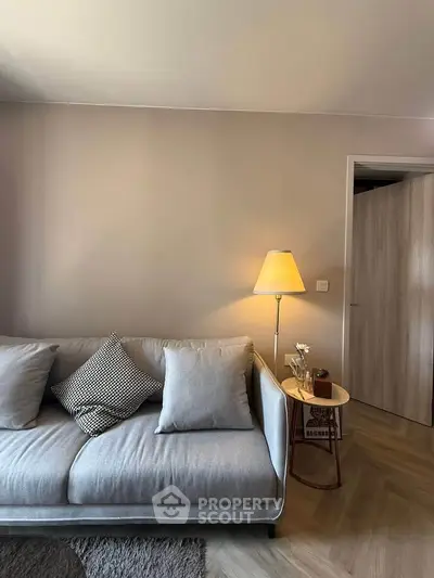 Modern living room with stylish sofa and warm lighting, perfect for cozy evenings.