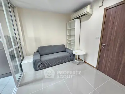 Cozy living room with modern sofa and air conditioning in a stylish apartment.
