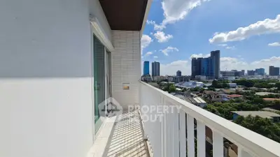 Spacious balcony with stunning city skyline view and modern architecture.