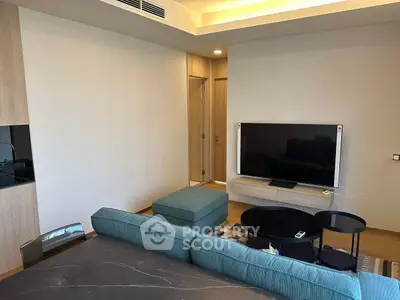 Modern living room with sleek TV setup and stylish furniture in a contemporary apartment.