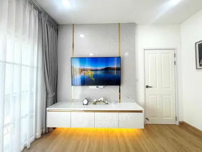 Modern living room with wall-mounted TV and elegant decor