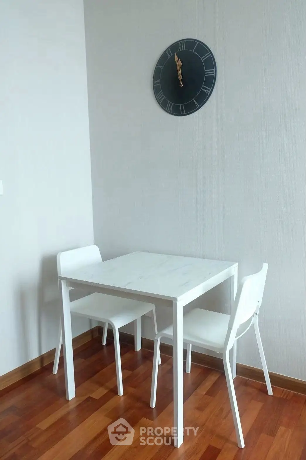 Cozy dining nook with modern white table and chairs, perfect for small spaces.