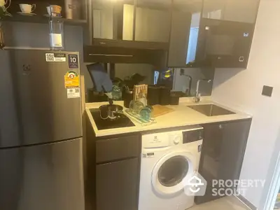 Modern compact kitchen with sleek appliances and washing machine