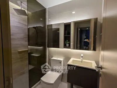 Modern bathroom with sleek fixtures and glass shower enclosure