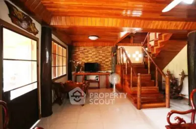 Charming wooden interior living room with staircase and natural light
