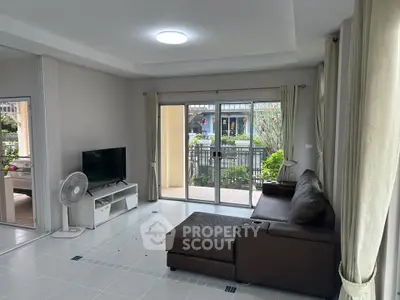 Spacious living room with modern decor and garden view