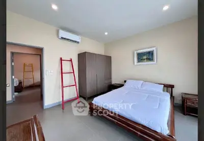 Spacious bedroom with modern furniture and air conditioning in a stylish apartment.