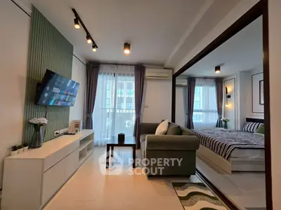 Modern living room with stylish decor and cozy bedroom view, perfect for urban living.