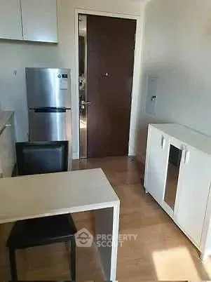 Compact kitchen with modern appliances and dining area