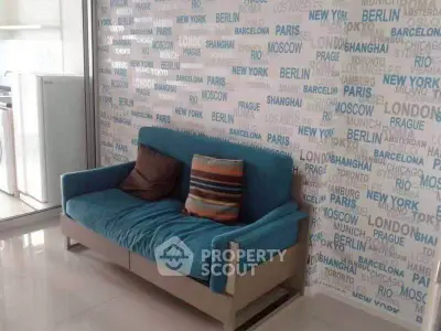 Stylish living room with modern blue sofa and city-themed wallpaper, perfect for urban living.