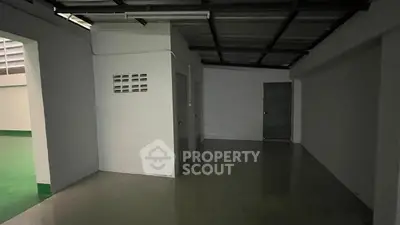 Spacious storage area with concrete flooring and metal ceiling