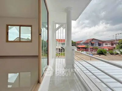 Spacious balcony with modern design and scenic neighborhood view, perfect for relaxation.