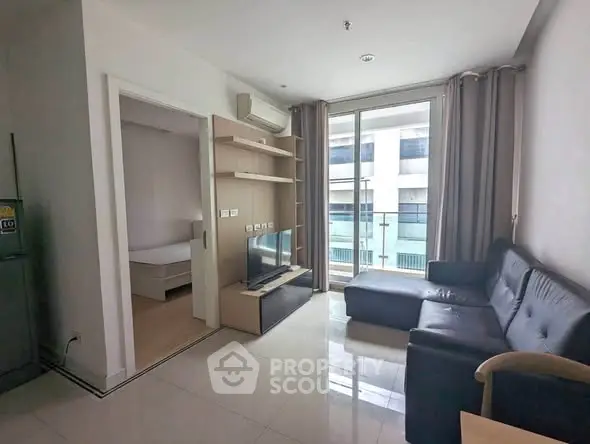 Modern living room with sleek furniture and balcony view in urban apartment
