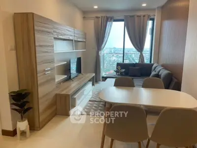 Modern living room with city view, stylish furniture, and natural light.