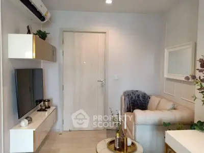 Cozy living room with modern decor and wall-mounted TV, perfect for relaxation.
