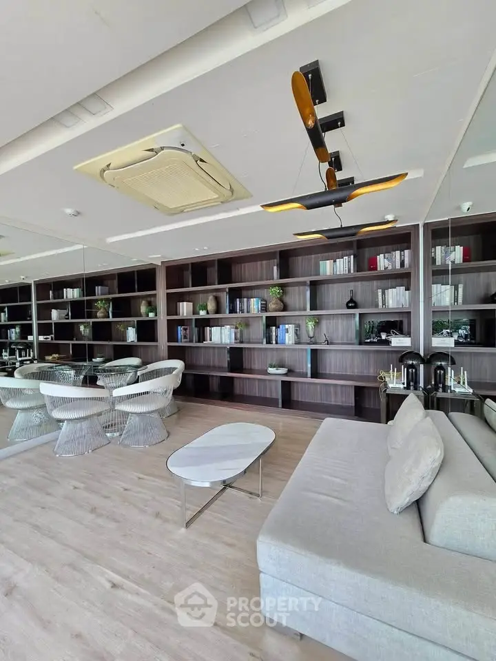Luxurious modern living room with elegant furniture and built-in bookshelves, perfect for sophisticated living.
