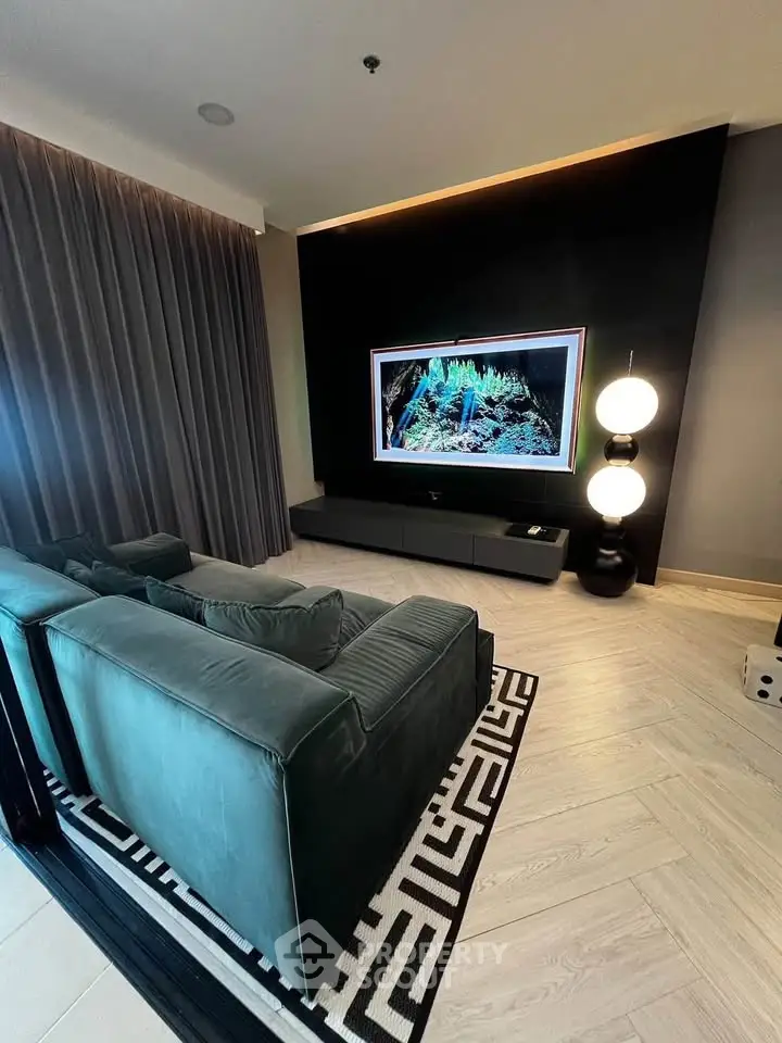 Luxurious living room with modern decor and large TV, perfect for entertainment and relaxation.