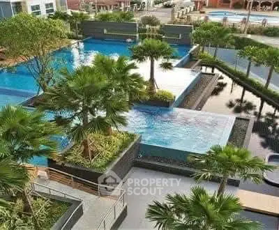 Luxurious outdoor pool area with lush greenery and modern design.