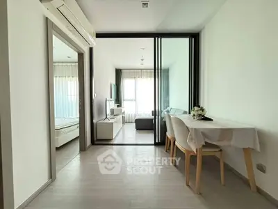 Modern apartment interior with open layout, featuring a cozy living area and dining space.