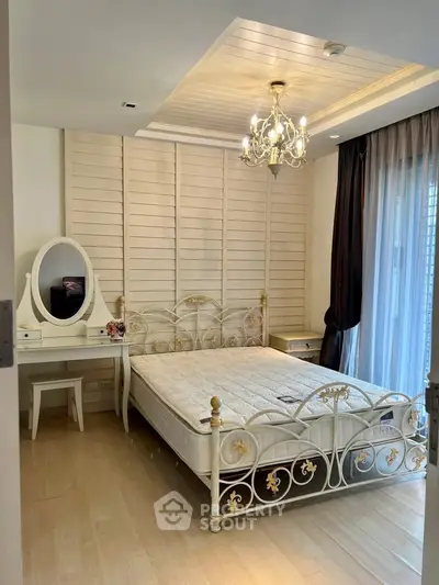 Elegant bedroom with vintage metal bed frame and chandelier lighting