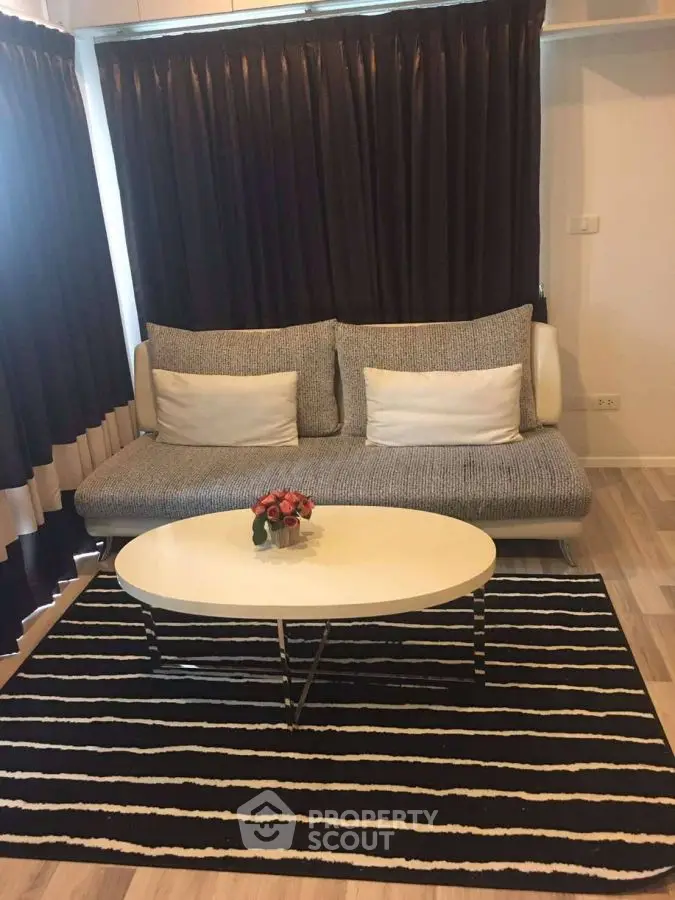 Modern living room with stylish sofa and striped rug