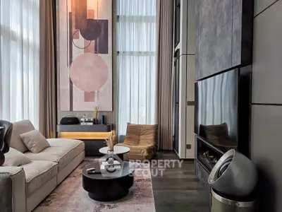 Luxurious modern living room with high ceilings, elegant decor, and large windows for natural light.
