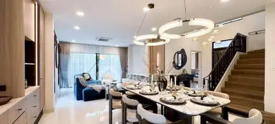 Luxurious open-plan living and dining area with elegant decor and modern lighting.