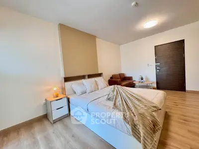 Spacious modern bedroom with cozy decor and wooden flooring