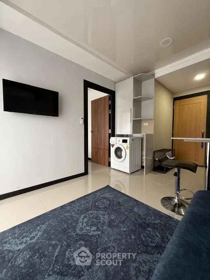Modern living room with sleek design and built-in washing machine