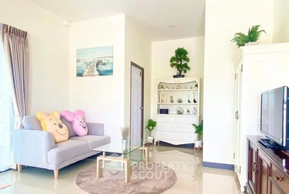 Charming living room with cozy sofa, glass coffee table, and elegant decor.