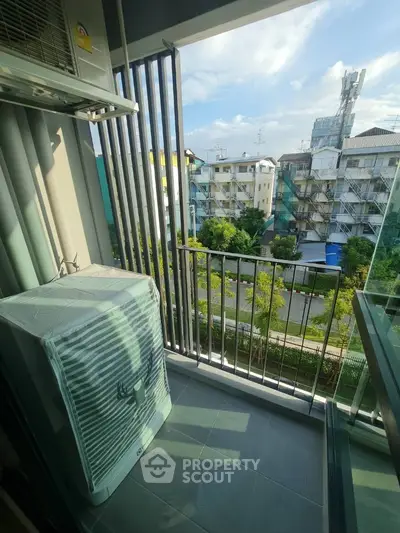 Charming balcony with city view and air conditioning unit in modern apartment