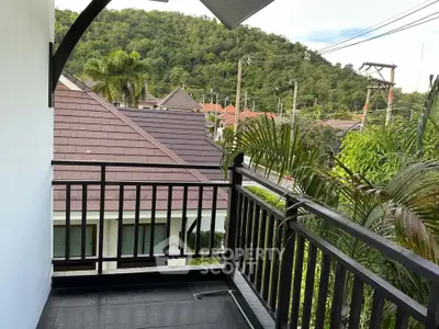 Charming balcony with scenic mountain view in a serene residential area.