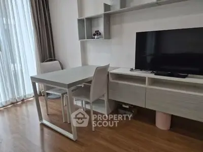 Modern living room with sleek furniture and large TV, perfect for relaxation and entertainment.
