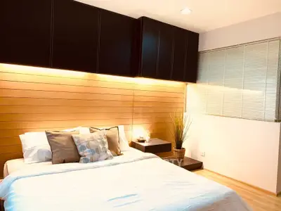 Modern bedroom with stylish wooden paneling and ambient lighting
