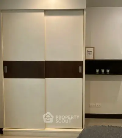 Modern bedroom with sleek sliding closet doors and minimalist decor