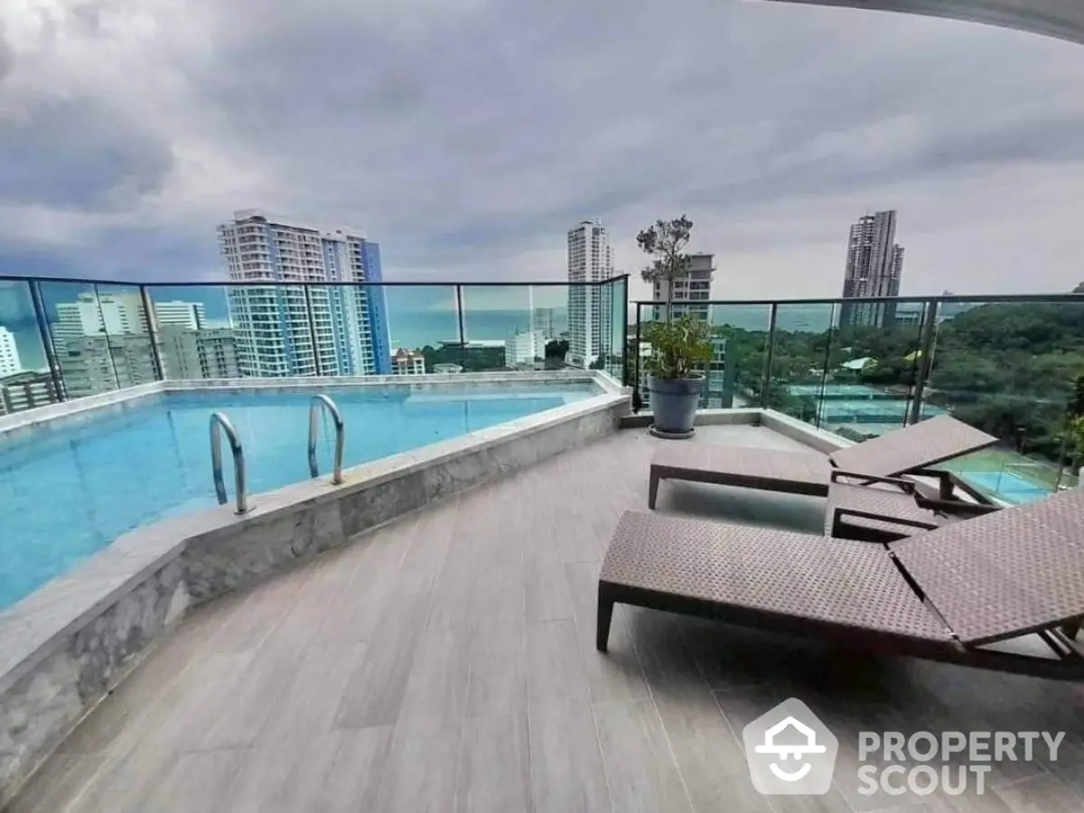 Luxurious rooftop pool with stunning city views and modern lounge chairs.