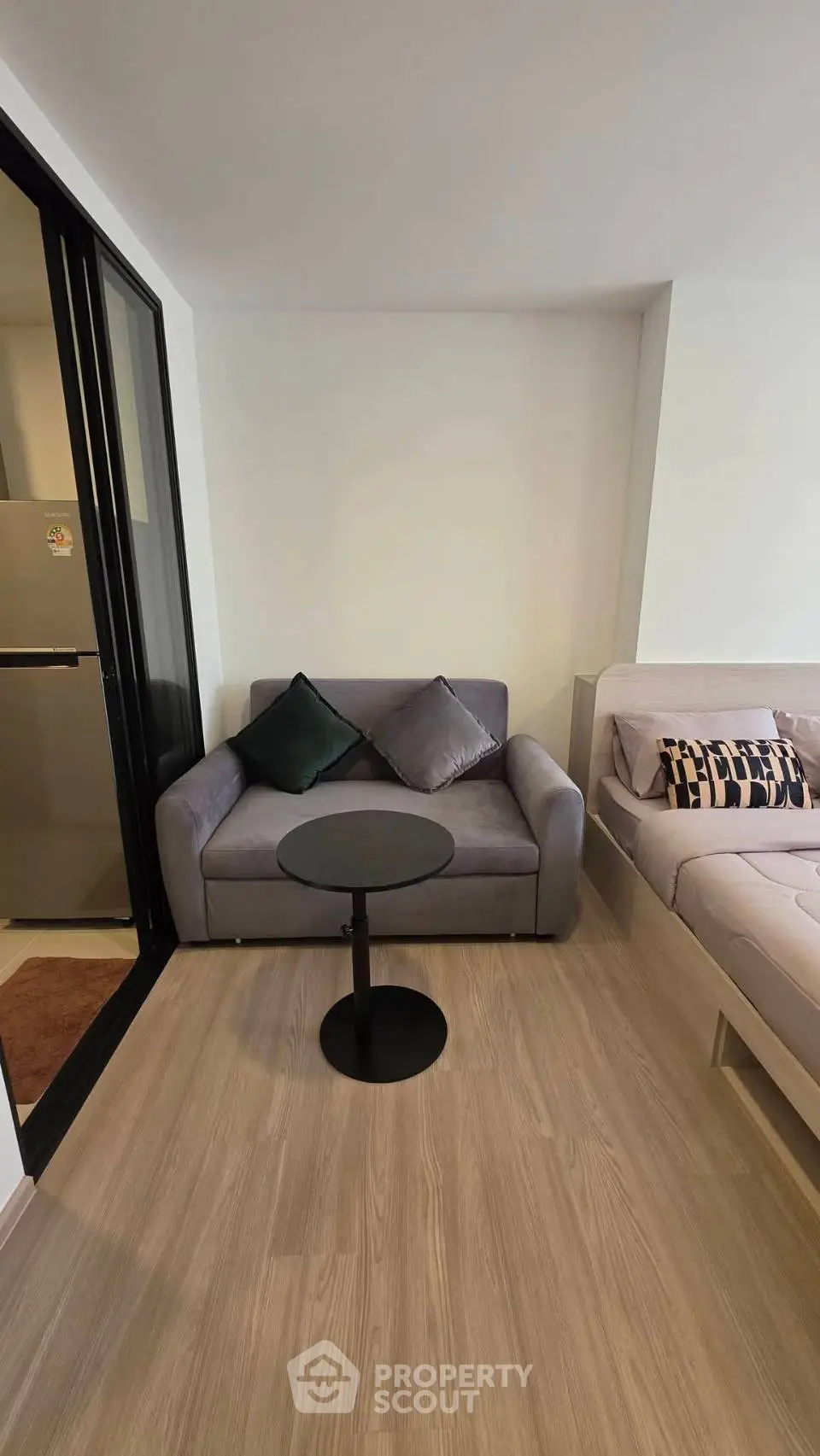 Cozy living room with modern sofa and stylish decor in a compact apartment.